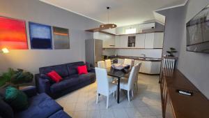 a living room with a couch and a table and chairs at Terry House in Sirmione