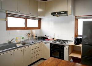 a kitchen with a sink and a stove top oven at リトリート奥入瀬屋 in Towada +19 photos