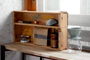 a wooden shelf with a bottle on a table at リトリート奥入瀬屋 in Towada