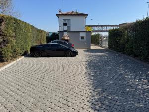 a black car parked in front of a building at OTB ITALIA - Airport Rooms in Treviso
