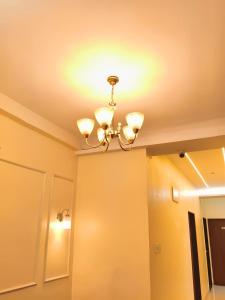 a ceiling with a chandelier in a room at Hotel Atithi Lodging in Pimpalgaon