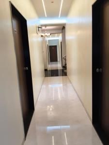 a hallway with two doors and a room with a hallway at Hotel Atithi Lodging in Pimpalgaon