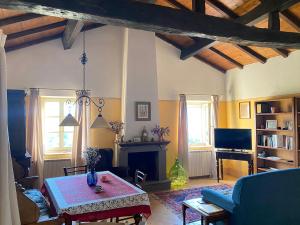 a living room with a table and a fireplace at Casa Rosmarino Malgrate in Filetto