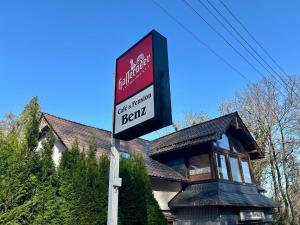 a sign in front of a house at Benz Café & Pension in Blankenburg