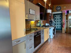 a kitchen with white cabinets and a stove top oven at Pension Hammoor in Hammoor