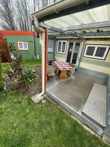 a patio with a picnic table in front of a house at Gite Raphael in Bourbourg +3 photos