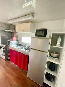 a kitchen with a refrigerator and a sink at Gite Raphael in Bourbourg