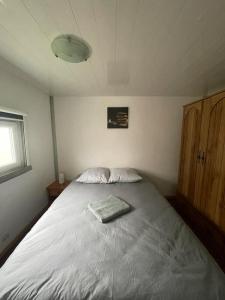 a bedroom with a large bed in a room at Gite Raphael in Bourbourg