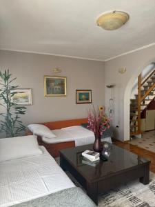 a living room with two beds and a coffee table at Poolhouse Domus in Solin +53 photos