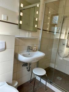 a bathroom with a sink and a shower at Benz Café & Pension in Blankenburg +2 photos