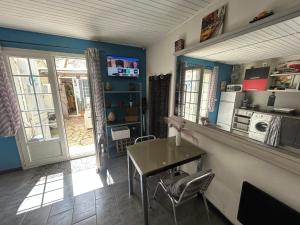 a kitchen with a table and chairs in a room at Studio sur agde, avec cour, parking et spa en option à 30e par jour in Agde +16 photos