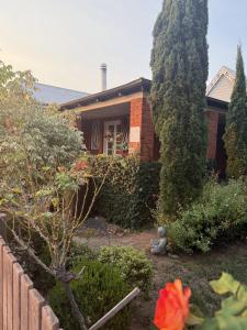 a house with a garden in front of it at The Residence - Spacious 4-Bed Tenterfield Home in Tenterfield