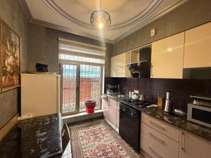 a kitchen with a sink and a stove top oven at Villa lux in Qusar
