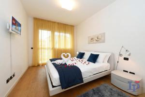 a bedroom with a bed with a swan decoration on it at The Wind Rose renovation 2025 DesenzanoLoft Official Partner Homes & Villas by Marriott Bonvoy in Desenzano del Garda