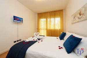 a bedroom with a bed with a stuffed animal on it at The Wind Rose renovation 2025 DesenzanoLoft Official Partner Homes & Villas by Marriott Bonvoy in Desenzano del Garda