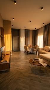 a living room with a couch and a table at Lanai Villas Beach Side in Baku
