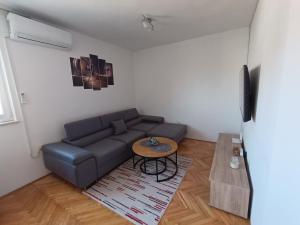 a living room with a couch and a table at Margareta's Apartment in Kaštela