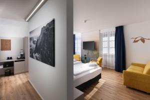 a hotel room with a bed and a living room at Hotel Engel in Stans