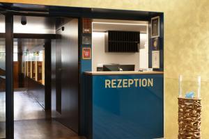 an entrance to a reception desk in a building at Hotel Engel in Stans