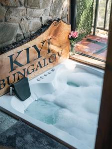 a jacuzzi tub in front of a window at Kiyi Bungalov in Çamlıhemşin +76 photos