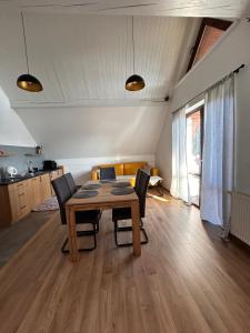 a dining room table and chairs in a room at Apartamenty na Rycerskiej in Czorsztyn +19 photos