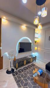 a living room with a flat screen tv on a wall at D2H résidence in Abidjan +7 photos