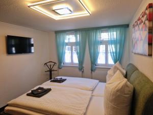 a bedroom with a bed and a window with blue curtains at Ferienwohnung Zum Alten Cafè in Neustadt +48 photos