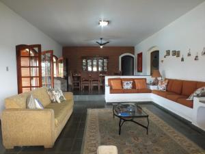 a living room with two couches and a table at Casa da Vó Lucia in Serra Negra