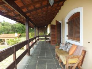 a porch of a house with a couch on it at Casa da Vó Lucia in Serra Negra