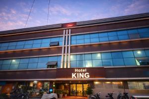 a building with a hotel king sign in front of it at Panch Aarohan Hotel King in Pithorāgarh