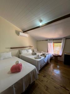 a room with two beds and a window at Vila Uryah in Caraíva +242 photos