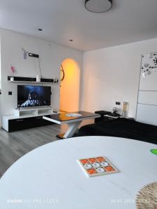 a living room with a bed and a tv at Atpūta pie Gora in Rēzekne