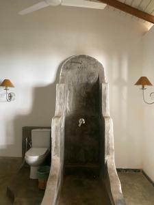 a bathroom with a toilet in the corner of a room at Amuura Beach Villa in Beruwala