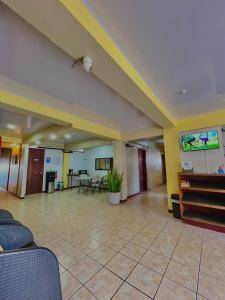 a large room with a lobby with a piano at Hotel Miami CR in Puerto Limón