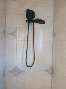 a shower in a bathroom with a shower head at Cocoplum Rest N Hideaway #2 in Nassau