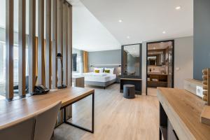 a large living room with a bed and a desk at Piazza Hotel und Restaurant in Aalen +48 photos
