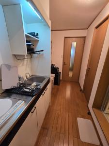 a kitchen with a sink and a counter top at Karawaru Stay 浦安 B303 Disney 9min in Tokyo