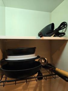 a shelf with a pan and utensils on it at Karawaru Stay 浦安 B303 Disney 9min in Tokyo