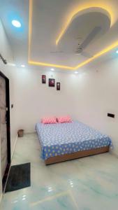 a bedroom with a bed with two pillows on it at SOALTEE Near Lucknow Airport in Lucknow