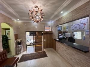 a lobby of a salon with a chandelier at Hotel Flor do Pari in São Paulo