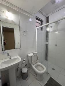 a bathroom with a toilet and a sink and a shower at Hotel Flor do Pari in São Paulo +6 photos