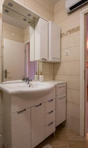a bathroom with a sink and a mirror at Apartment Marta in Ražanac +58 photos