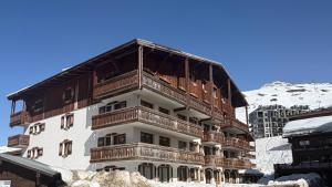 a large building with wooden balconies in the snow at Studio Tignes Val Claret in Tignes