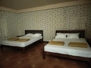 two beds sitting next to each other in a room at The Wild Deck - Chikkamagaluru in Chikmagalūr +20 photos