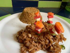a plate of food with rice and a piece of bread at Résidence KEUR FLEURIE in Rufisque