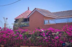 a house with pink flowers in front of it at Résidence KEUR FLEURIE in Rufisque