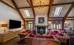 a living room with a large couch and a tv at The Hideaway in Banchory