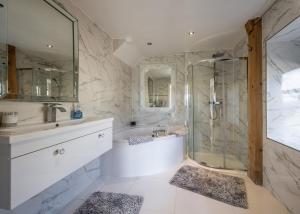 a bathroom with a shower and a tub and a sink at The Hideaway in Banchory +52 photos