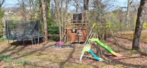 a playground in the woods with two swings at Boningal in Moissac
