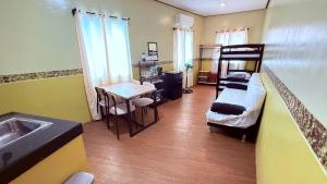 a small room with a bunk bed and a sink at Dexter John's Guesthouse in Agus